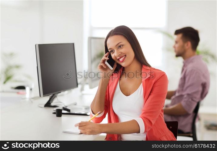 business, startup, communication and people concept - happy african american businesswoman or creative worker calling on smartphone at office