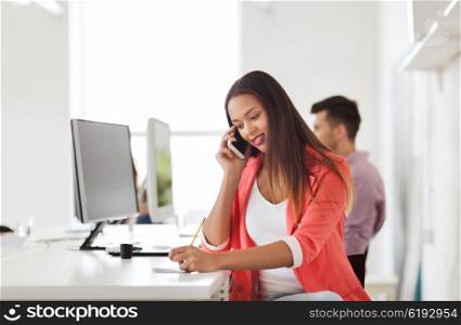 business, startup, communication and people concept - happy african american businesswoman or creative worker calling on smartphone at office