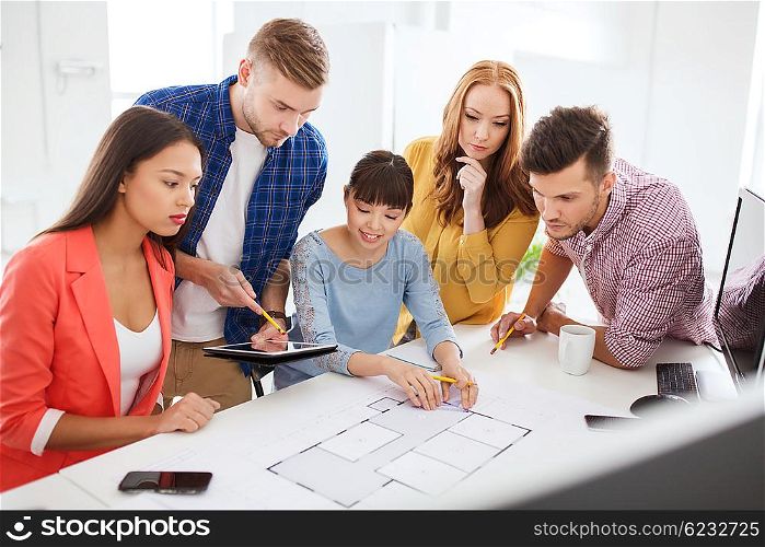 business, startup, education and people concept - creative architect team or students with blueprint working at office
