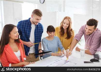 business, startup, education and people concept - creative architect team or students with blueprint working at office. creative team with blueprint working at office