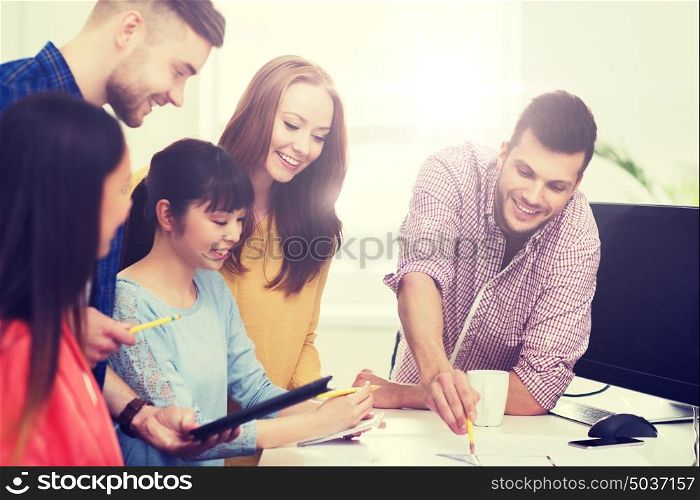 business, startup, education and people concept - happy creative architect team or students with blueprint working at office. happy creative team or students working at office