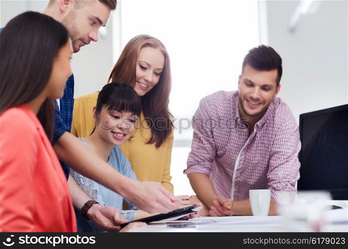 business, startup, education and people concept - happy creative team or students with tablet pc computer working at office