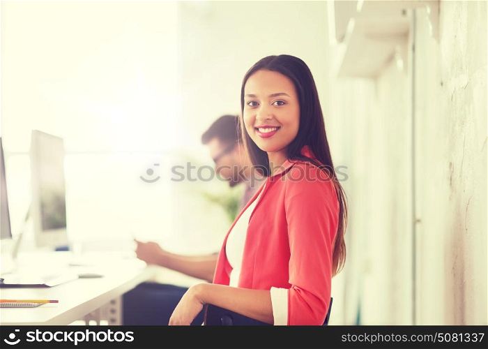 business, startup, education and people concept - happy young african woman with computer working at office. happy african woman with computer at office