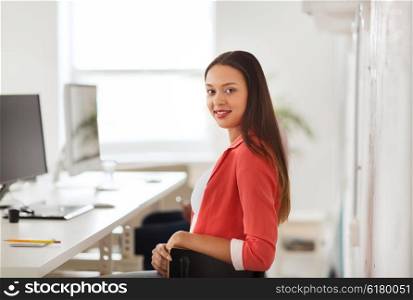 business, startup, education and people concept - happy young african woman with computer working at office