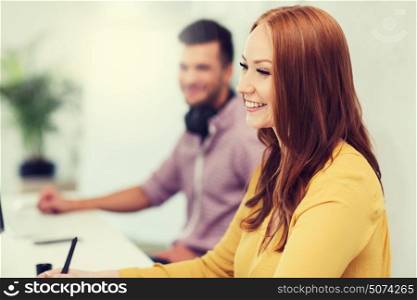 business, startup, education and people concept - happy young creative redhead woman with pc computer over man or student working at office. happy creative team or students working at office