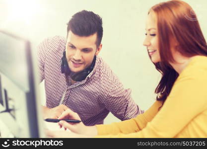 business, startup, education, technology and people concept - creative team or students with headphones and computer at office. creative team with headphones and computer