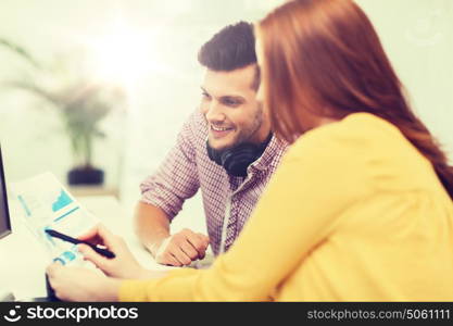 business, startup, education, technology and people concept - creative team or students with headphones and computer at office. creative team with headphones and computer