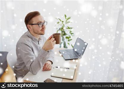business, startup, inspiration and people concept - happy businessman or creative male worker with notebook or diary drinking coffee and thinking at home office over snow