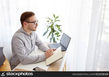 business, startup, inspiration and people concept - happy businessman or creative male worker with notebook or diary thinking at home office