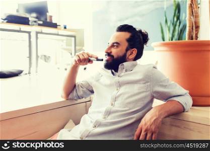 business, startup, inspiration and people concept - happy latin man with beard and hair bun at office