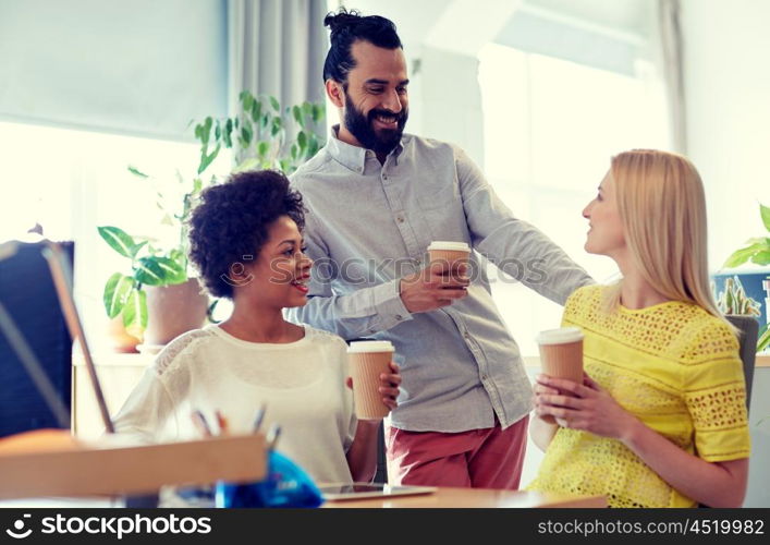 business, startup, people and teamwork concept - happy creative team drinking coffee in office