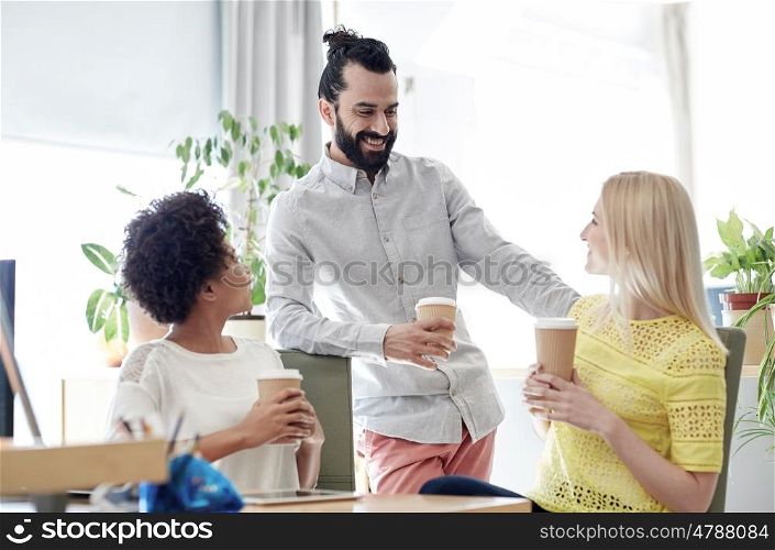 business, startup, people and teamwork concept - happy creative team drinking coffee in office
