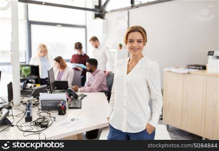 business, startup, people and teamwork concept - happy woman over creative team in office. happy young woman over creative team in office. happy young woman over creative team in office