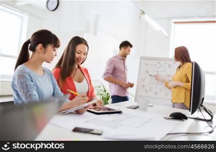 business, startup, planning, strategy and people concept - happy creative team with tablet pc computer and flip board on conference at office