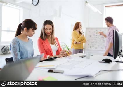 business, startup, planning, strategy and people concept - happy creative team with tablet pc computer and flip board on conference at office