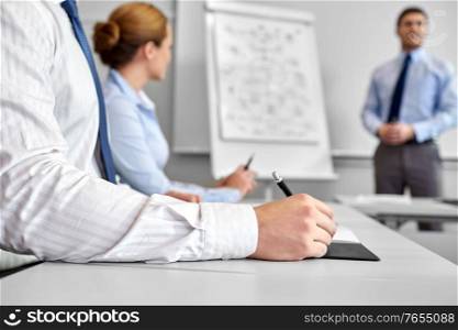 business, startup, presentation, strategy and people concept - close up of businessman with pen on conference at office. business team with scheme on flipboard at office