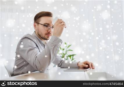 business, startup, stress, problem and people concept - businessman or creative male worker with smarphone at office over snow