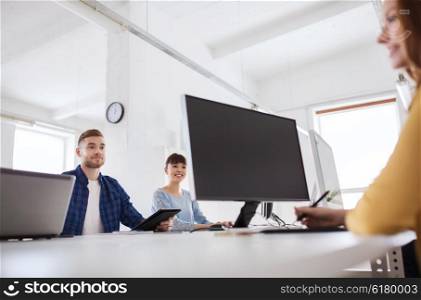 business, startup, technology and people concept - happy creative team with computers at office