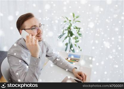business, startup, technology, communication and people concept - happy businessman or creative male worker with computer calling on smarphone at home office over snow