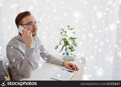 business, startup, technology, communication and people concept - happy businessman or creative male worker with computer calling on smartphoneat home office over snow