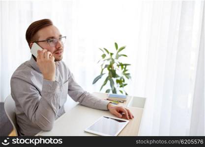 business, startup, technology, communication and people concept - happy businessman or creative male worker with computer calling on smarphone at home office