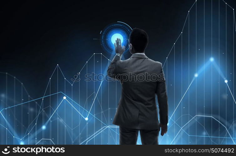 business, statistics, people and technology concept - businessman working with virtual chart projection from back over black background. businessman working with virtual chart projection