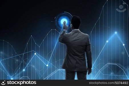 business, statistics, people and technology concept - businessman working with virtual chart projection from back over black background. businessman working with virtual chart projection