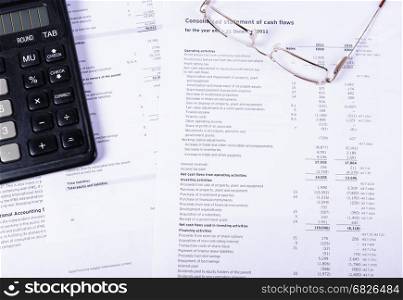Business still - life-documents, glasses and calculator. Financial documents lying on their glasses and calculator.
