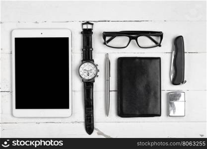Business still-life with tablet computer glasses and cigarette lighter on white boards. Business still-life with tablet computer glasses and cigarette l