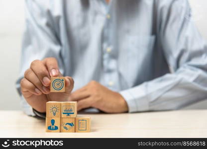 business strategy Action plan Goal and target icons with hand stack a wood cube block on a table. Copy space company development startup concept.