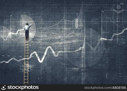 Business strategy. Back view of businessman standing on ladder and drawing sketch on wall