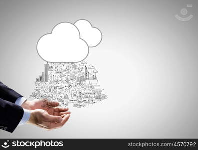 Business strategy. Close up of businessman hand holding cloud with business sketches