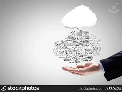 Business strategy. Close up of businessman hand holding cloud with business sketches