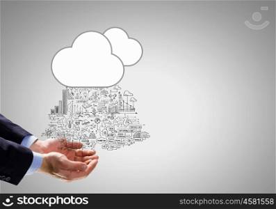 Business strategy. Close up of businessman hand holding cloud with business sketches
