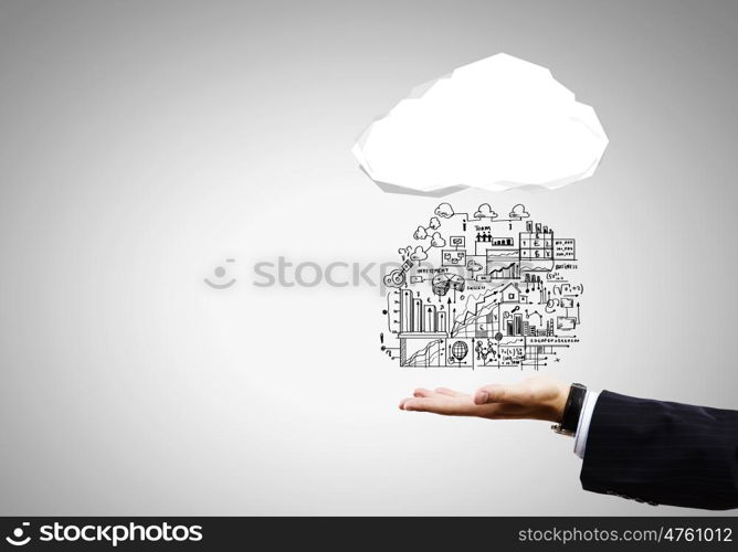 Business strategy. Close up of businessman hand holding cloud with business sketches