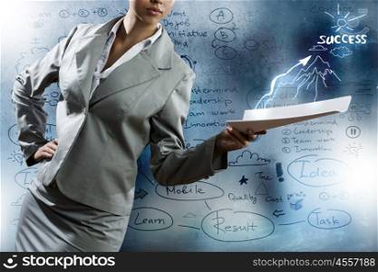 Business strategy. Close up of businesswoman with papers in hand