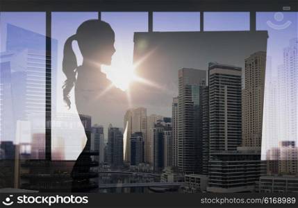 business, strategy, planning and people concept - silhouette of woman with flipboard over double exposure office and city background