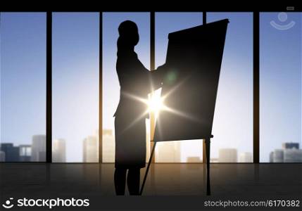 business, strategy, planning and people concept - silhouette of woman with flipboard over office window background