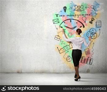 Business strategy planning. Back view of businesswoman drawing business sketch on wall