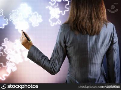 Business strategy. Rear view of businesswoman drawing puzzles with pen