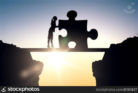 business, strategy, startup, development and people concept - silhouette of woman moving puzzle piece over sun light background