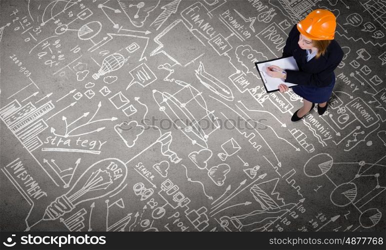 Business strategy. Top view of businesswoman looking at business sketches