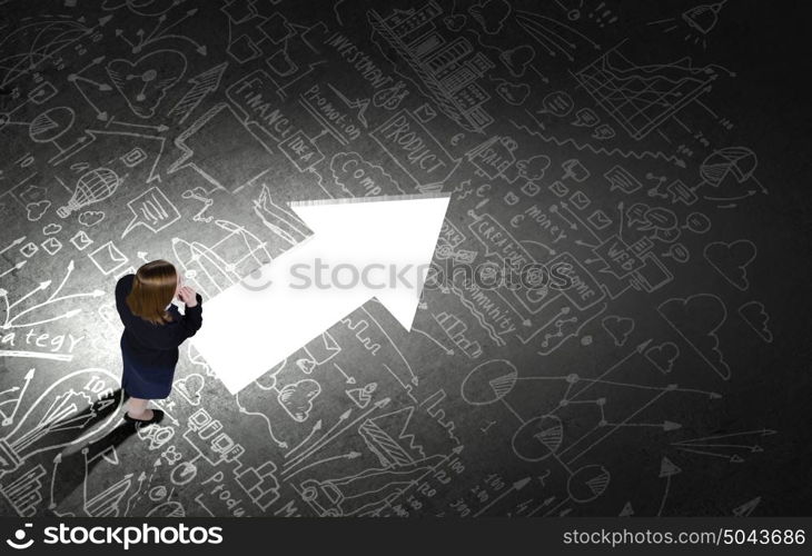 Business strategy. Top view of businesswoman looking at business sketches