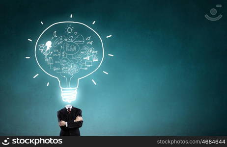 Business strategy. Unrecognizable businessman with business sketches instead of head on blue background