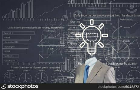 Business strategy. Unrecognizable businessman with business sketches instead of head on cement background