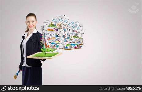 Business strategy. Young businesswoman with paint brush and wooden frame
