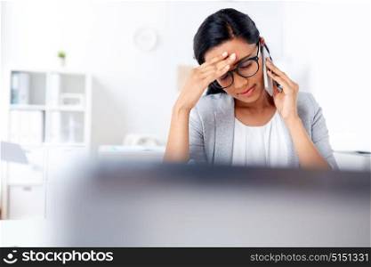 business, stress and people concept - businesswoman calling on smartphone at office. businesswoman calling on smartphone at office