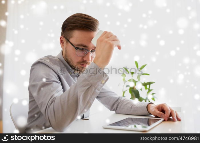 business, stress, fail, technology and people concept - businessman or creative male worker with smartphoneat home office over snow