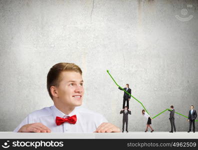 Business structure. Businessman looking from under the table at businessteam