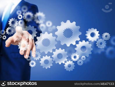 Business structure. Image of businessman touching gear elements. Mechanism concept